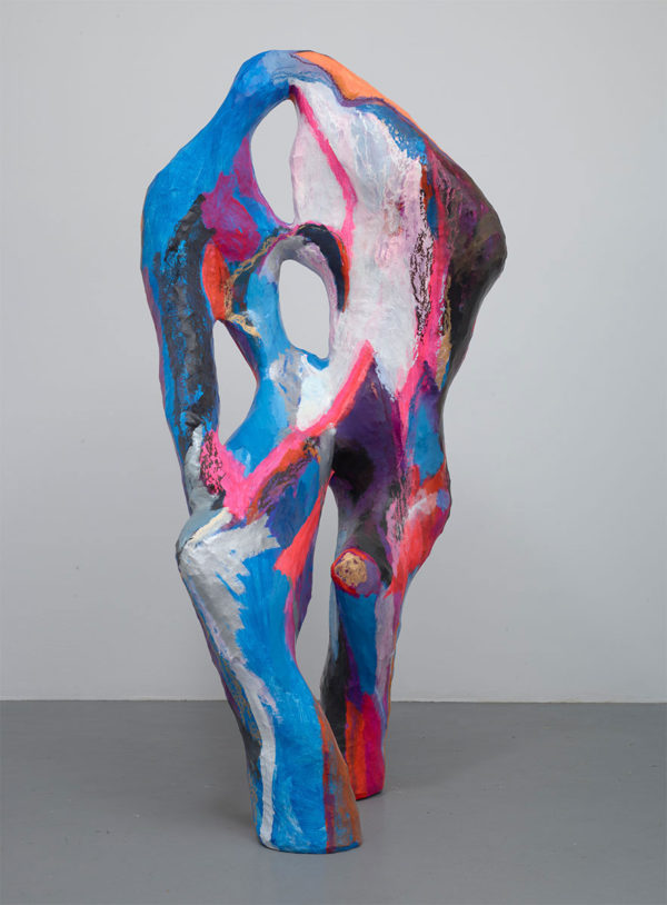 A sculpture by Bianca Beck, made of wood, wire, and papier-mâché, painted with oil and acrylic in a set of blues, pinks, white and purple. It looks figurative and is quite tall, about 240" tall.